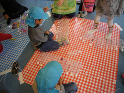 children are connecting up bottle and bottle